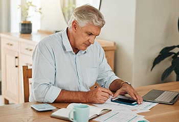 Man calculating how much cataract surgery will cost