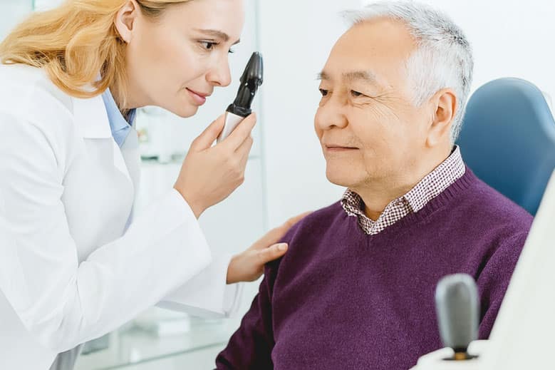 Woman eye doctor performing a glaucoma eye exam after Tube Shunt surgery.