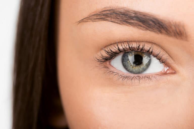 Close-up photo of a human eye showing the cornea and pupil, illustrating how LASIK works to correct vision.