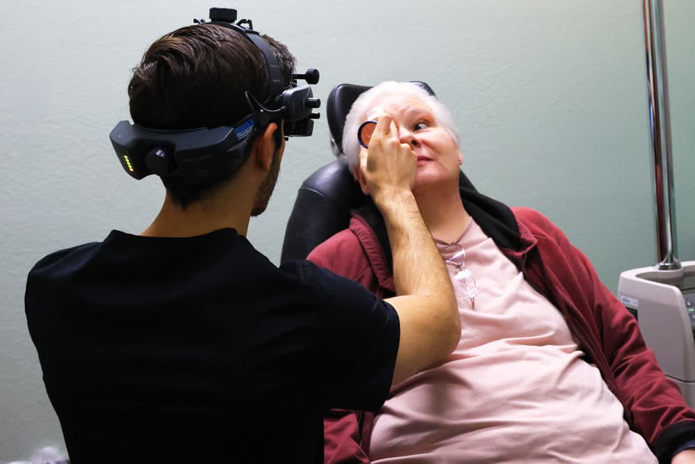Vitreomacular traction is a condition in which the vitreous of the eye pulls on the macula. Doctor is checking patient eye.