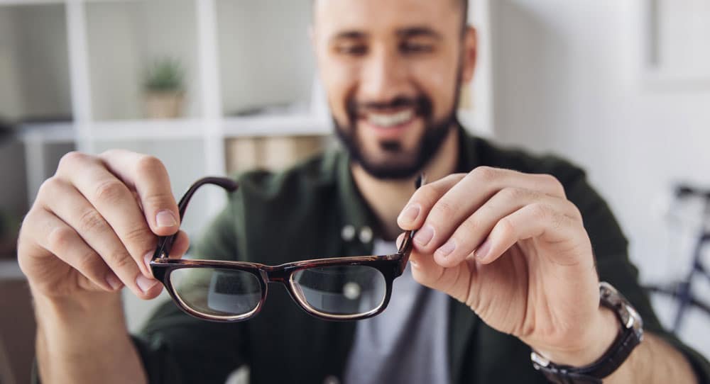 Man with glasses thinking about PRK.