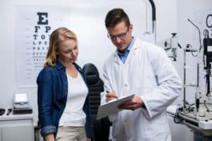 eye doctor discussing test results with female patient