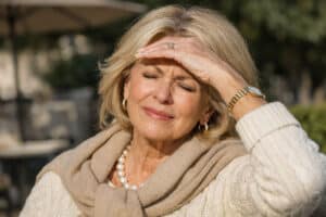 iridodonesis causing light sensitivity in an attractive senior woman outdoors at Barnet Dulaney Perkins