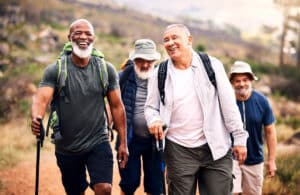 Group of senior men hiking together, representing active lifestyles supported by presbyopia symptoms diagnosis and treatment