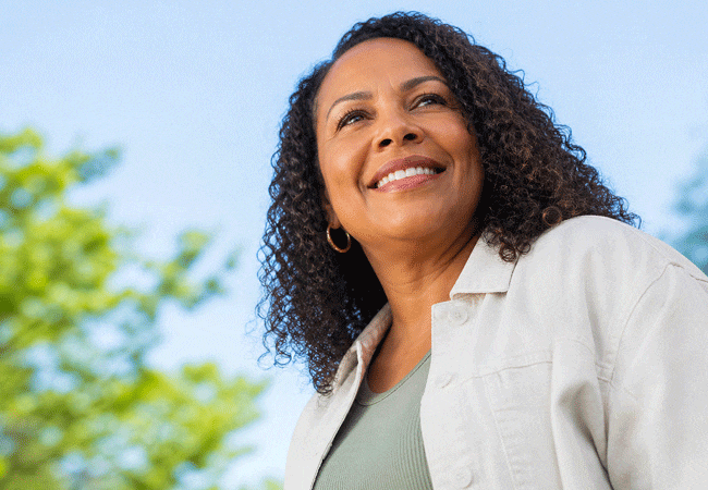 Senior woman enjoying the sunny day after learning more about her Chronic Dry Eye Causes and Treatments available at Barnet Dulaney Perkins.