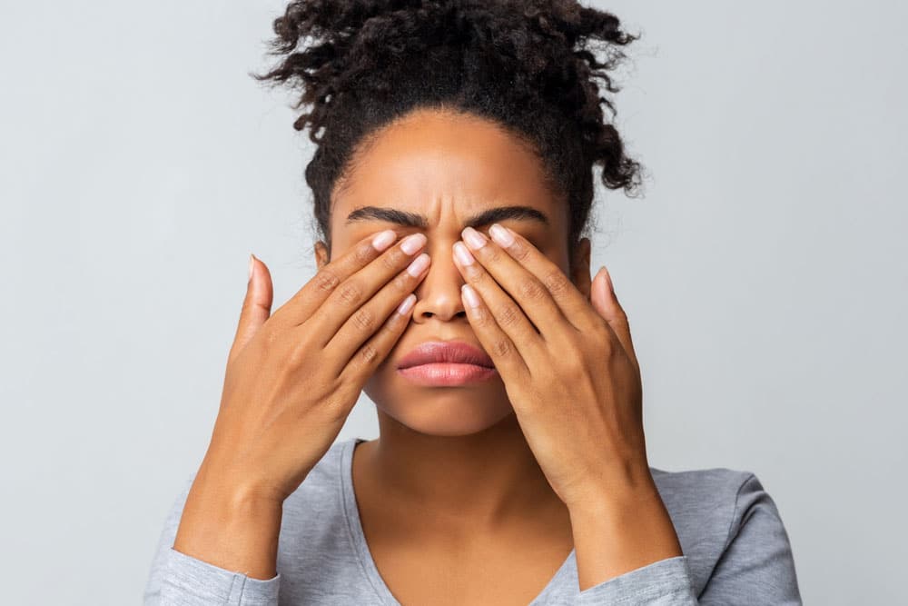 Woman rubbing dry eyes during the day and night.