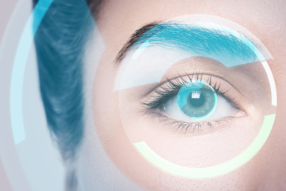 Close-up of a blue eye with translucent circular HUD graphics overlay.