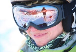 Woman wearing ski goggles demonstrating how to take care of your eyes this winter