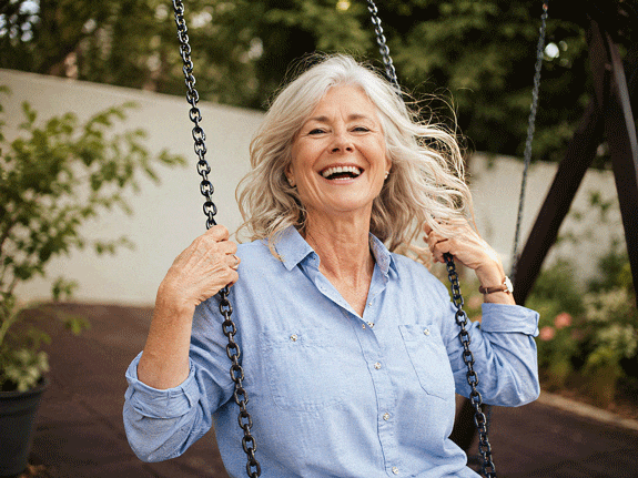 Senior woman singing carefree after her successful cataract surgery recovery at Barnet Dulaney Perkins in Scottsdale, Arizona.