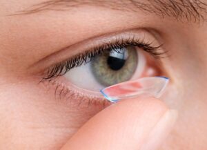 Close-up of a woman placing a soft specialty contact lens on her eye at Barnet Dulaney Perkins Eye Center.