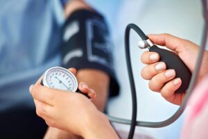 Blood pressure being checked by a nurse to see if hypertensive retinopothy, find treatment at Barnet Dulaney Perkins.