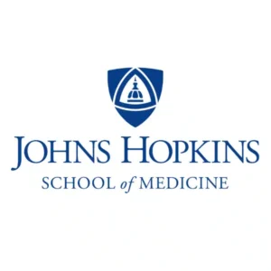 Johns Hopkins School of Medicine logo with a blue shield emblem and the words Johns Hopkins School of Medicine.