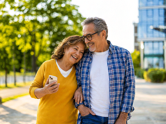 Senior Hispanic couple take a relaxing walk together after cataract surgery after LASIK at Barnet Dulaney Perkins in Phoenix, Arizona.