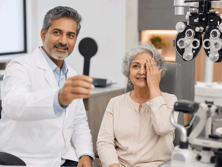 Barnet Dulaney Perkins Eye Center ophthalmologist performing a visual acuity test on a senior patient to evaluate blurry vision, sudden spots, and other changes in visual clarity.