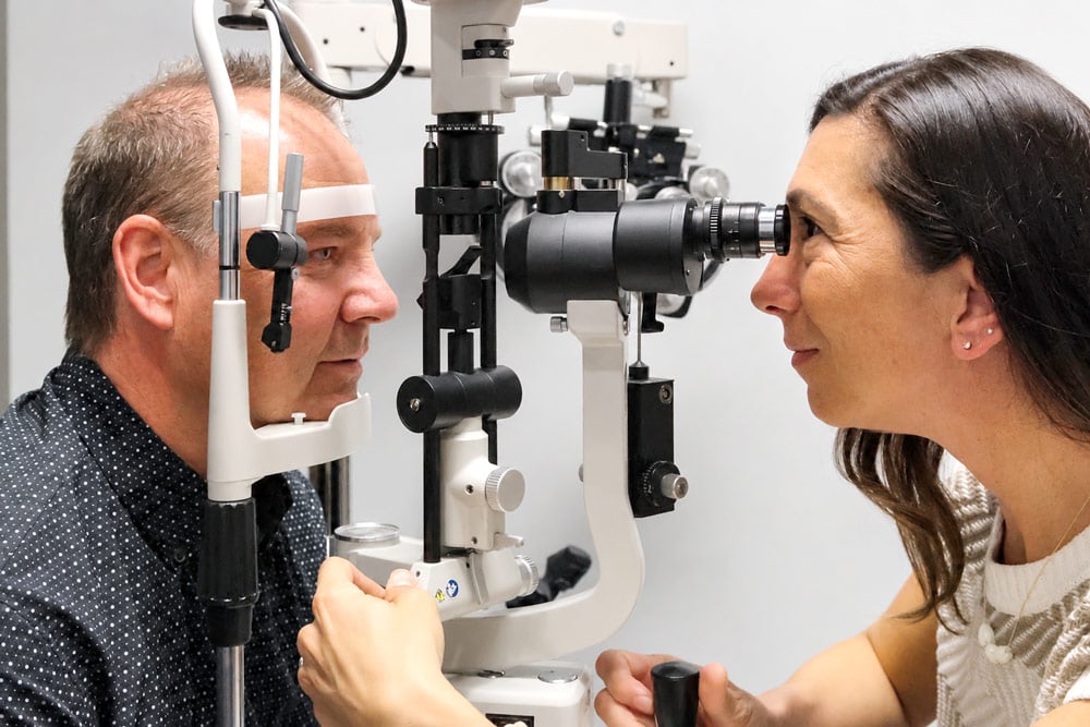 Dr. Christine Funke performs a slit-lamp eye exam for a patient during a glaucoma evaluation.