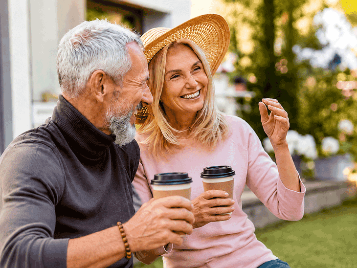 Smiling senior couple relaxing outdoors, representing lifestyle goals after evaluation for keratoconus symptoms at Barnet Dulaney Perkins Eye Center.