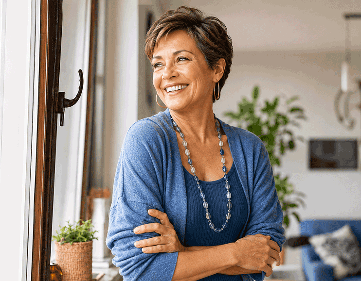 Smiling Hispanic senior woman at home, supporting high eye pressure vs glaucoma education from Barnet Dulaney Perkins Eye Center.