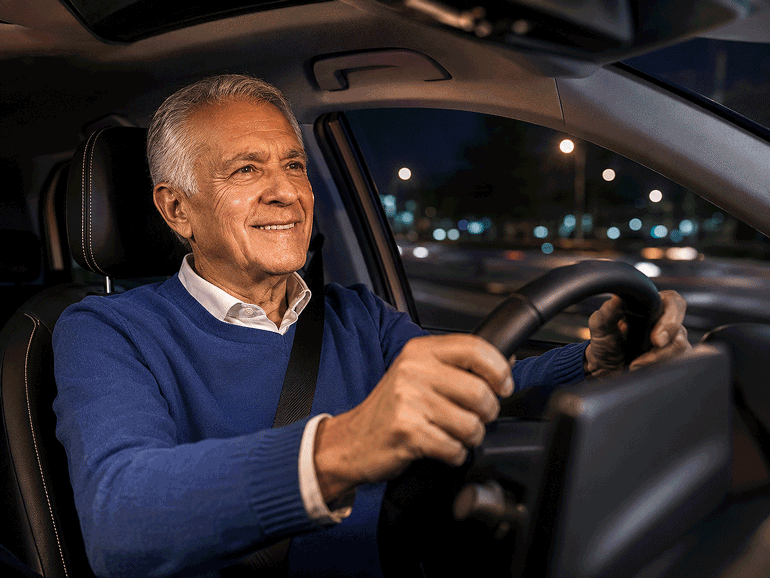 Senior man driving at night, illustrating night blindness and difficulty seeing in low-light conditions.