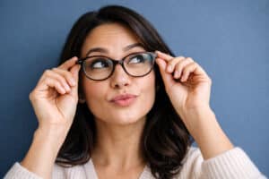 Woman wearing new properly fitting glasses fixing her problem of squinting with glasses from her visit to Barnet Dulaney Perkins.